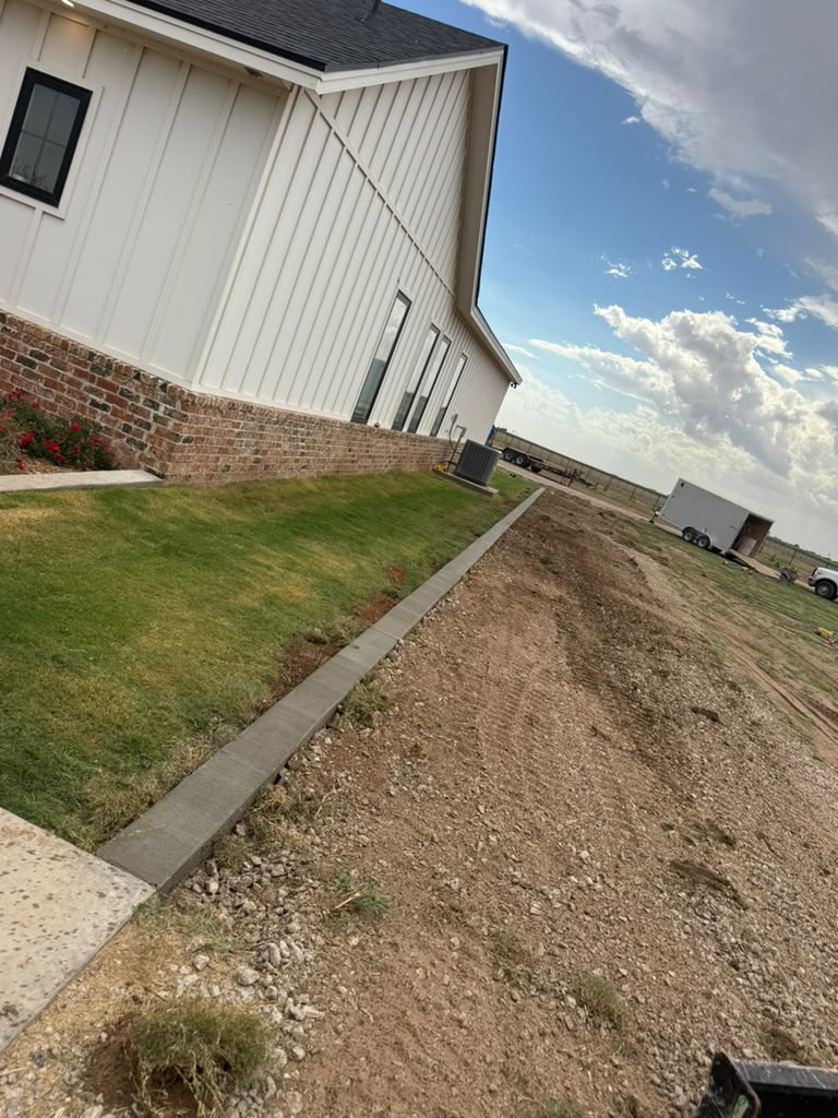 Finished concrete edging along the side lawn.