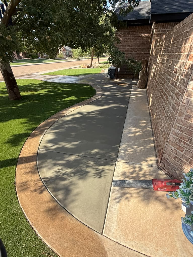 New sidewalk with a broom finish and stained border, Lubbock.