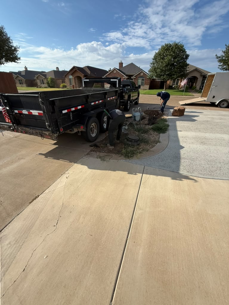 Crew preparing the curved driveway edge for new concrete work.