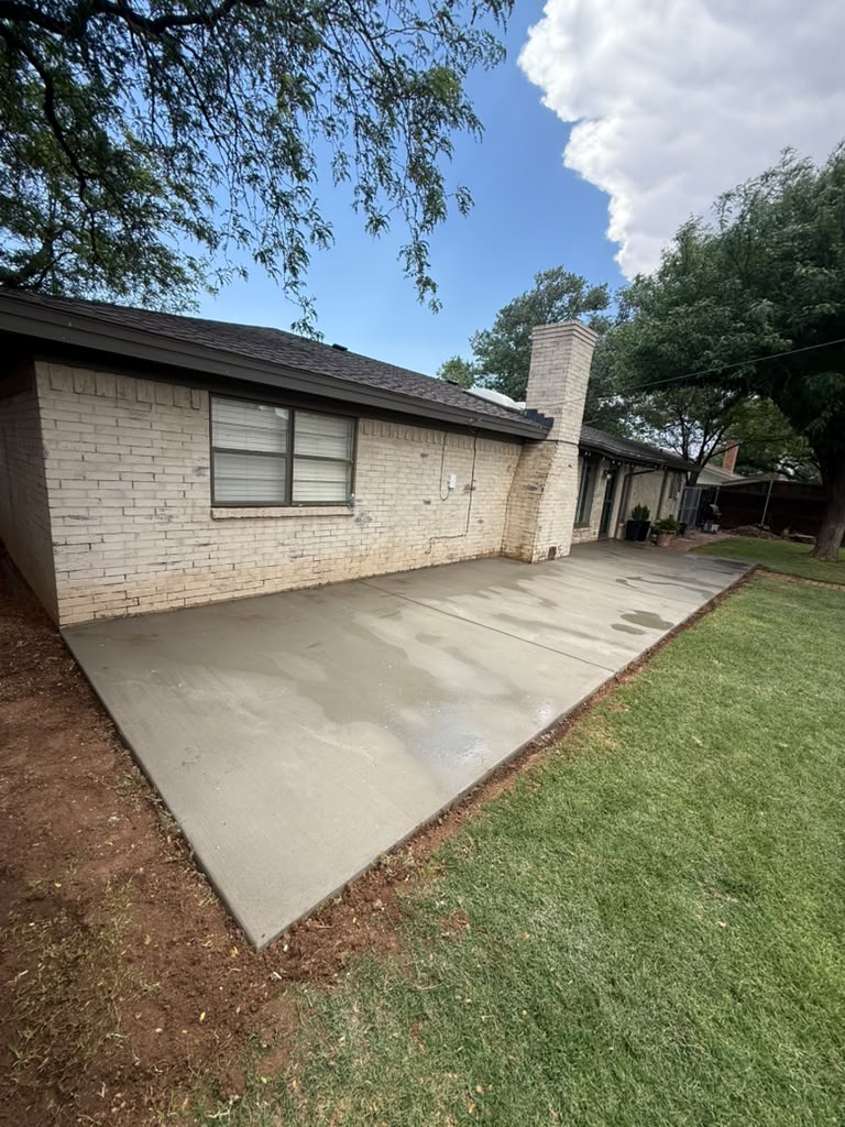 Broom-finished flatwork poured along the back of the house.