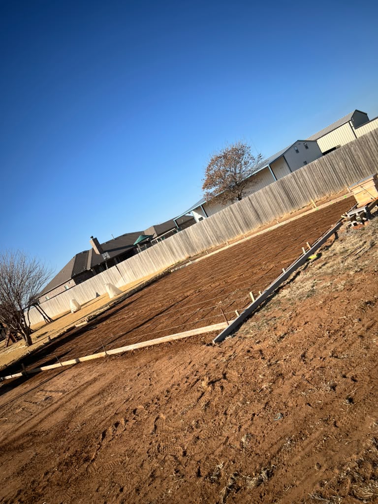 Reinforcement and perimeter forms set for a large backyard slab.